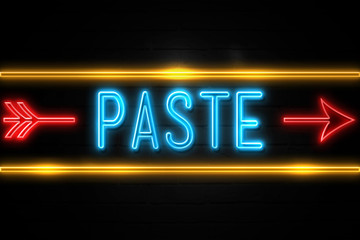Paste  - fluorescent Neon Sign on brickwall Front view
