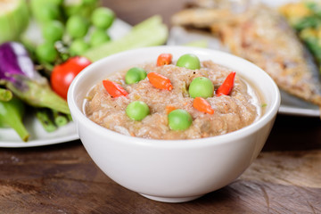 Thai food (Nam Prik Kapi),shrimp paste chili dip with fried mackerel omelette and fresh vegetables on wooden background