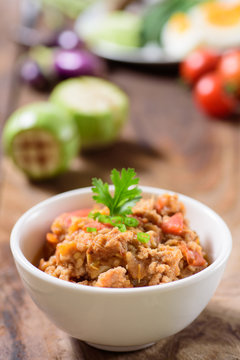 Thai Northern food (Nam Prik Ong) with vegetables on wooden background,spicy tomato with pork,red chili dip,NorthernThai dipping sauce