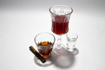 liquor and cigar in glass on isolated white background