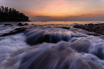 Beautiful Seascape with sea and rock on sunset background.