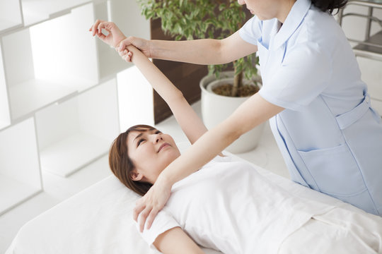 Female massager is doing arm massage