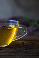 Green tea with herbals. Tea with oregano on the wooden background
