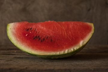 Watermelon slices on the woodan table. Fresh red watermelon. Rustical style.