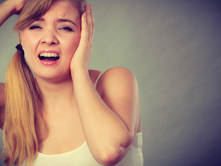 Woman suffering from headache migraine pain.