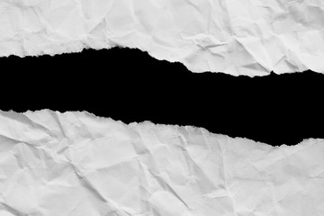 Torn white paper with a black background