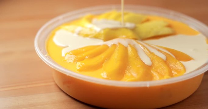 Pouring milk to mango pudding
