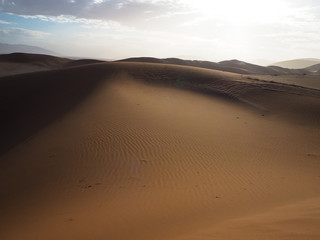 Soft natural rusty red sand dune and salt pan of vast desert landscape copyspace background with hot sunlight, Sossus, Namib desert