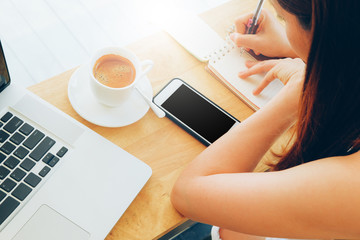 woman has good time for work with laptop and  mobile in coffee shop the nice place of work space