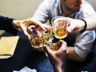 Foto auf Acrylglas Alkohol Hands clinging alcohol drink glasses