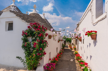 Fototapeta na wymiar Alberobello (Italy) - The incredible little white town in Apulia region, province of Bari, southern Italy, famous for its unique trulli buildings. Here the historic center in a summer day