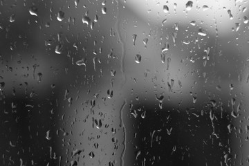 Water drops on house window with blur background.