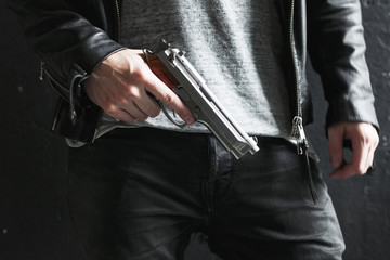 Hand holding pistol ready to shoot - obrazy, fototapety, plakaty