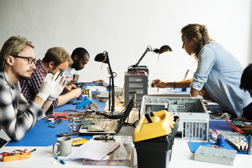 Electronics technicians team working on computer parts