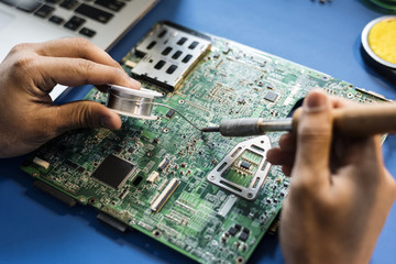 Closeup of tin soldering with electronics circuit board - obrazy, fototapety, plakaty