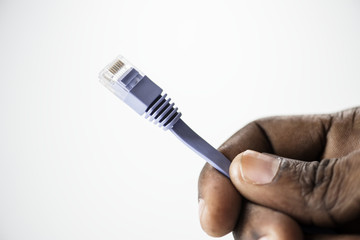 Hand holding LAN cable isolated on background