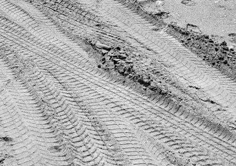Tyre tracks on sand in black and white