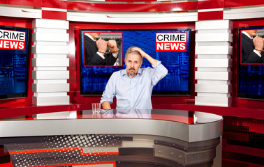 Crime news. A television anchorman at studio