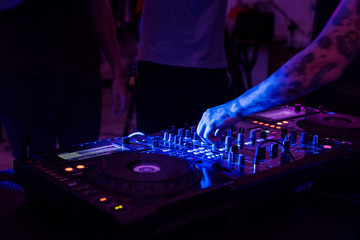 Obraz premium Hand on a sound mixer in a party