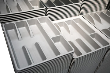 Fototapeta premium Stacks and Rows of grey plastic cutlery tray. Easy to fit in kitchen drawer