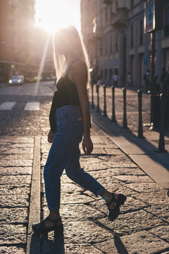 Young cool woman in the city at sunset