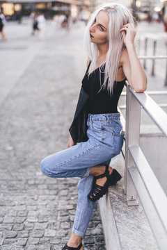 Young cool woman in the city at sunset