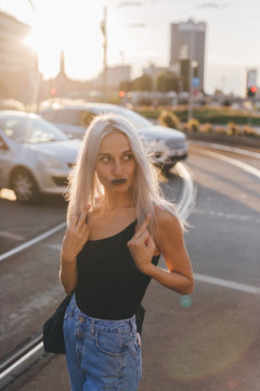 Young cool woman in the city at sunset