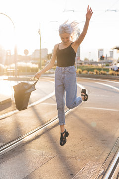 Young cool woman in the city at sunset