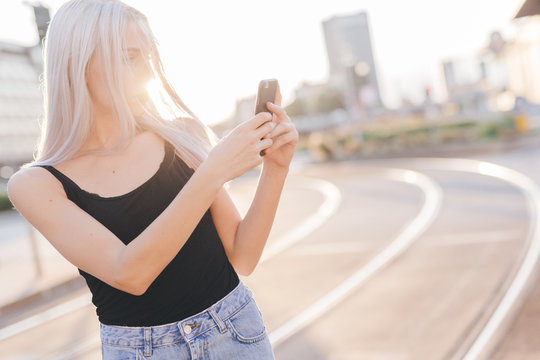 Young cool woman in the city at sunset