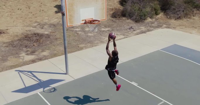 Man Playing Basketball at Park Outside, Overhead Shot