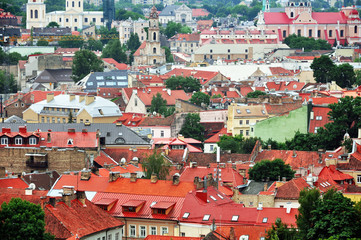 Naklejka premium Fragment of the old town Vilnius panorama with red roofs and towers of churches. Lithuania.