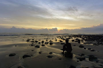 silhouette of men at the beach on the sun rise