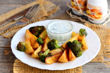 Baked potatoes with broccoli and sour cream sauce. Tasty and healthy vegetarian recipe for weight loss. Closeup