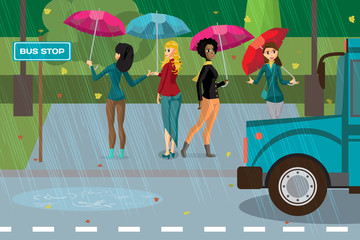 Women under umbrellas in the rainy autumn weather are at the bus