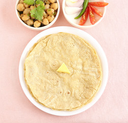 Jowar roti or sorghum flat bread, which is an healthy Indian vegetarian food made from the dough of sorghum flour.