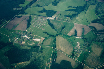 Aerial top view of land, green fields, roads