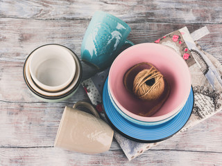 Ceramic crockery tableware on wooden background. Pastel vintage color bowls, dishes, cups