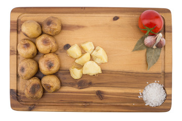 Baked potatoes on a wooden board. Isolated on white background.