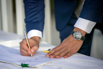 Young Man Signing a Document