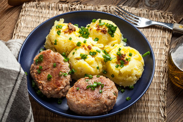 Meatballs served with boiled potatoes.