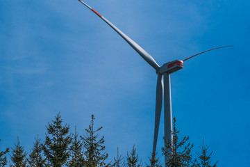 Windenergyplant in front a blue sky