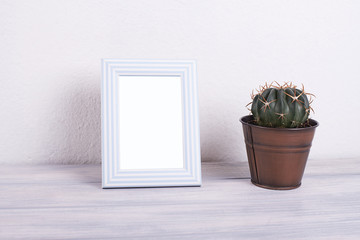Photo frames next to decorative objects and lavender flower on white and blue wood table. Decor.
