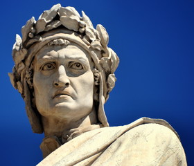 Denkmal des Dante Alighieri mit ernstem Blick vor blauem Himmel 