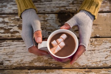 Cropped  hand of woman having hot chocolate