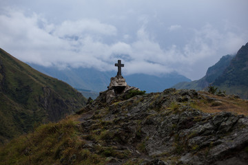 GEORGIA, KAZBEGI Orthodox cross near Caucasus mountains.