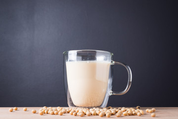Glass with Soy Milk and Seeds on background