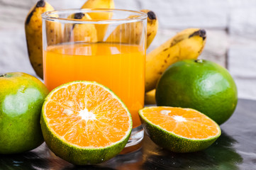Fototapeta na wymiar orange juice and tropical fruits