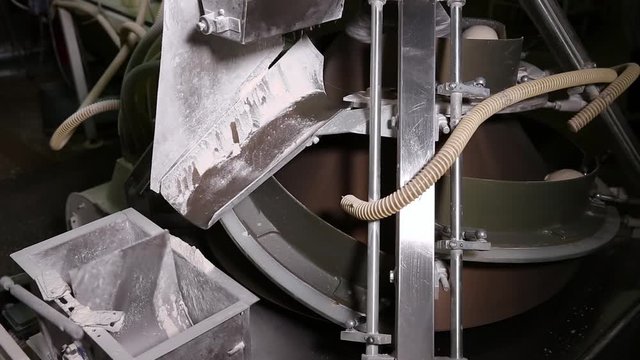Automated production of bread. Conveyor with bread. Raw bread moves along the conveyor belt in the bakery. Preparing dough for baking breads. Equipment for production of bread. Video includes sound.