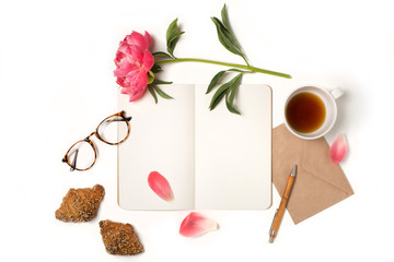 Open notebook with empty pages mockup, pen, glasses, cup of coffee, croissants and pink peony flower. Blank letter on pink peach background, top down view. - obrazy, fototapety, plakaty