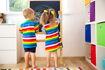 little child drawing on the blackboard